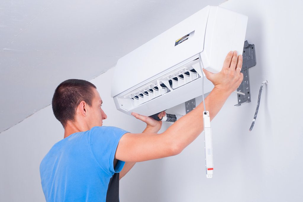 HVAC Technician installing air conditioning unit