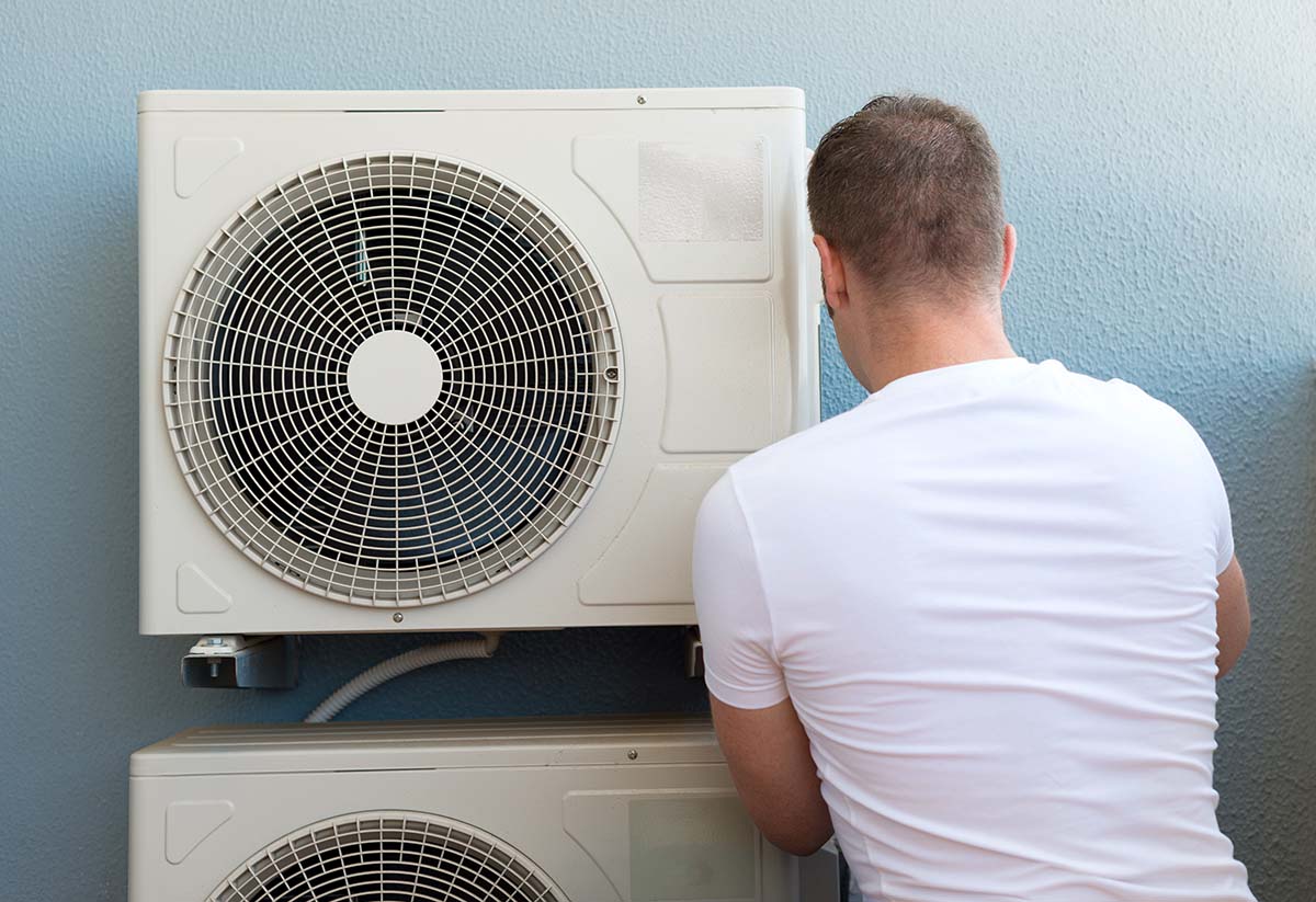Technician installing air conditioning unit